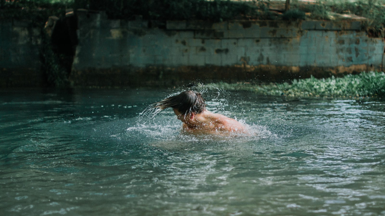 man swimming on water during daytime